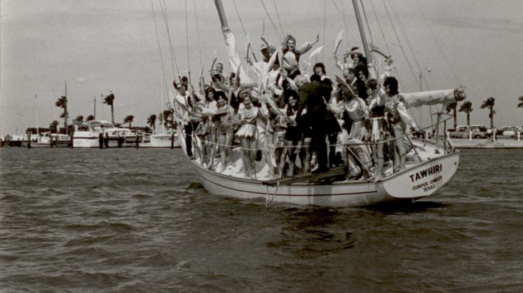 Mayor McIver Furman holds on before being ordered to jump into Corpus Christi Bay by citizen “pirates" for Buc Days.