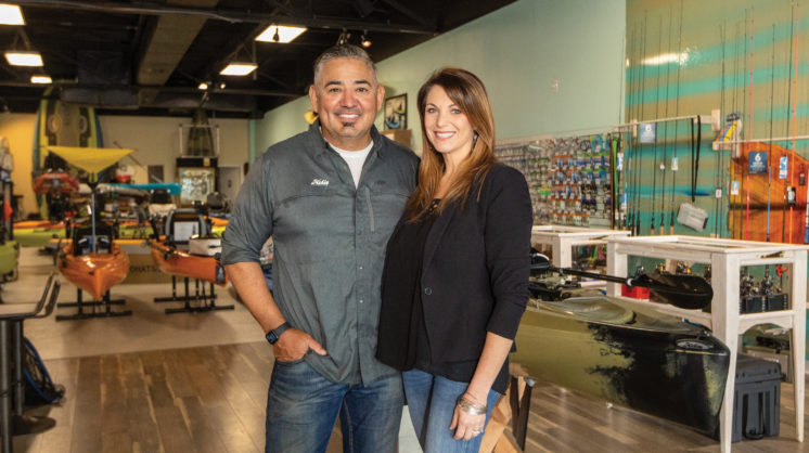 Fin Factory owner Mike Morales and wife stand in Fin Factory store.