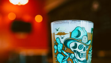 A glass of beer on tap in the ambient setting of Rebel Toad Brewing Company.