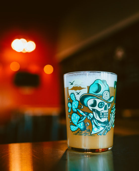 A glass of beer on tap in the ambient setting of Rebel Toad Brewing Company.