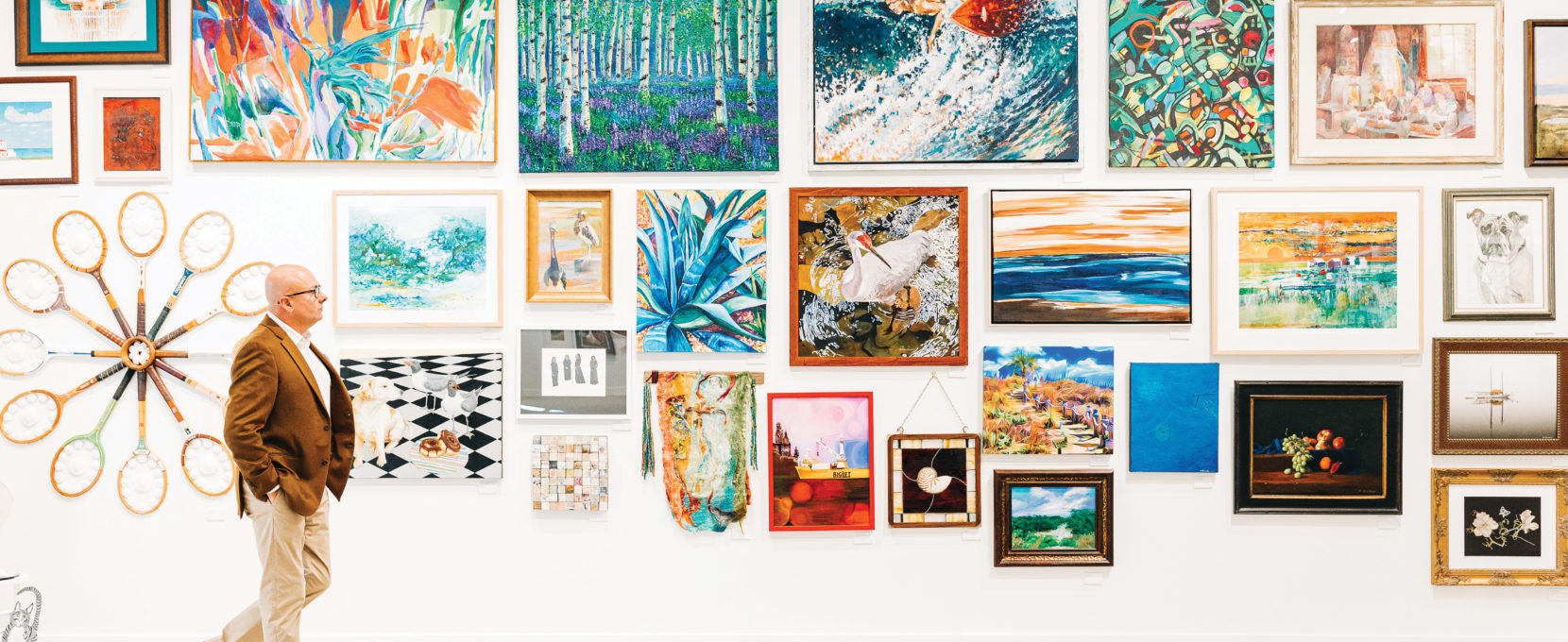 A man stands admiring an installation of work in the new Rockport Center for the Arts facility.