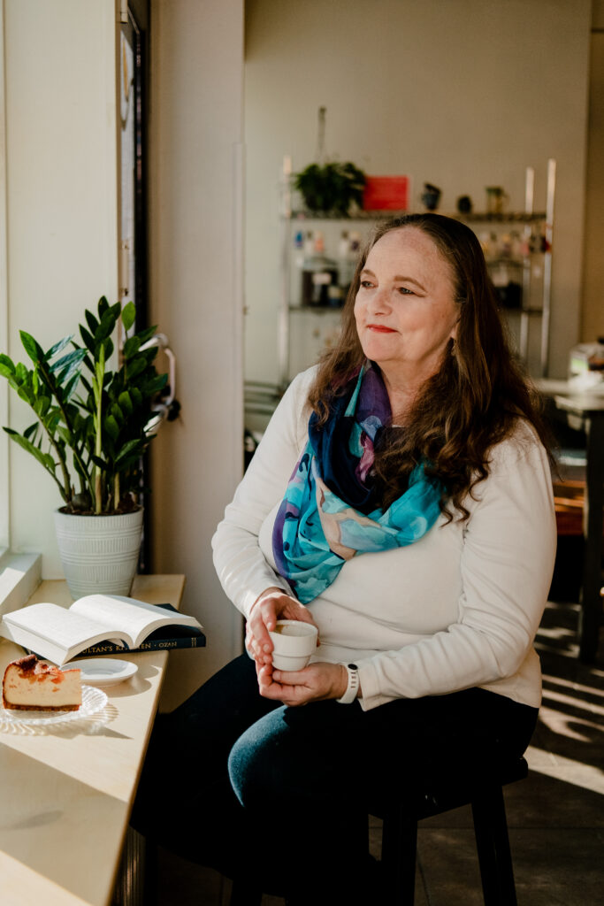 Cafe Calypso's owner Marcy Okumus sits in the cafe's new downtown Corpus Christi location.