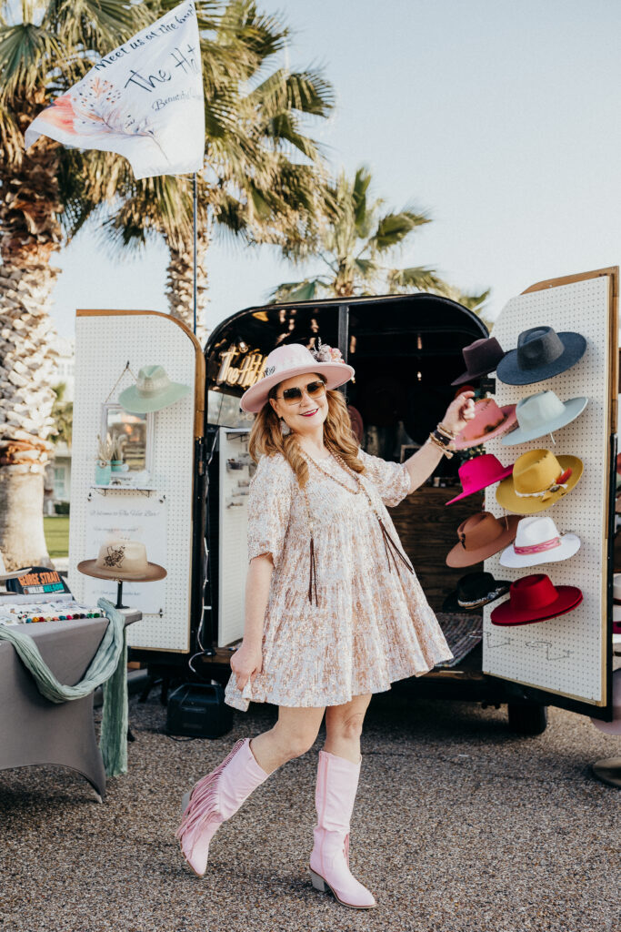 The Hat Bar Co. owner Ginny Moss stands in front of her Coastal Bend pop-up hat shop.