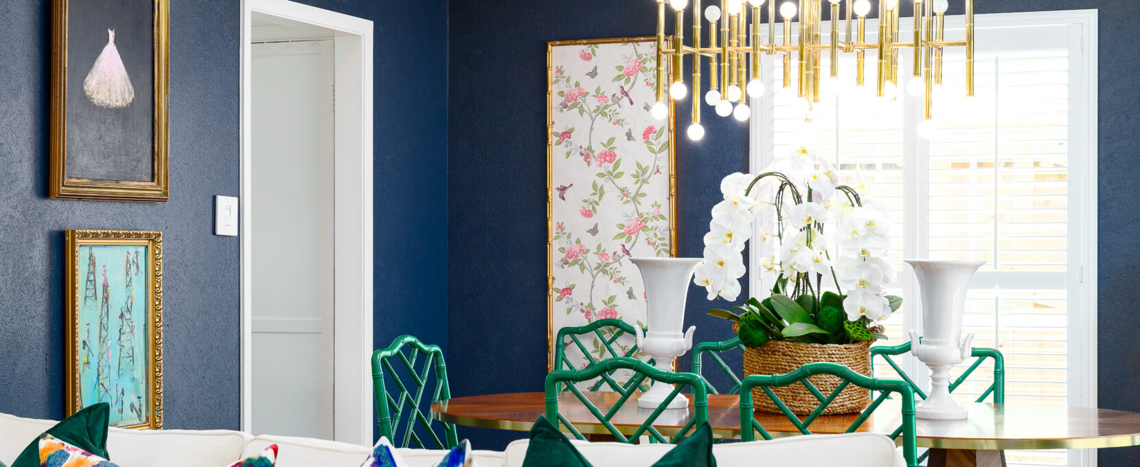 Looking over the couch on the cozy living room into a stylish, chic dining room of a Corpus Christi family home.