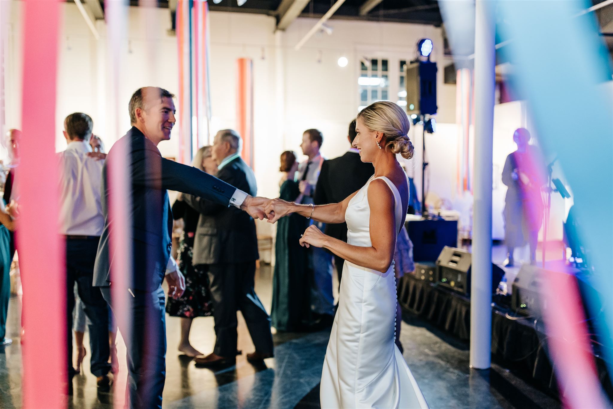 Love is in the air as this couple takes their first dance surrounded by colorful ribbons.