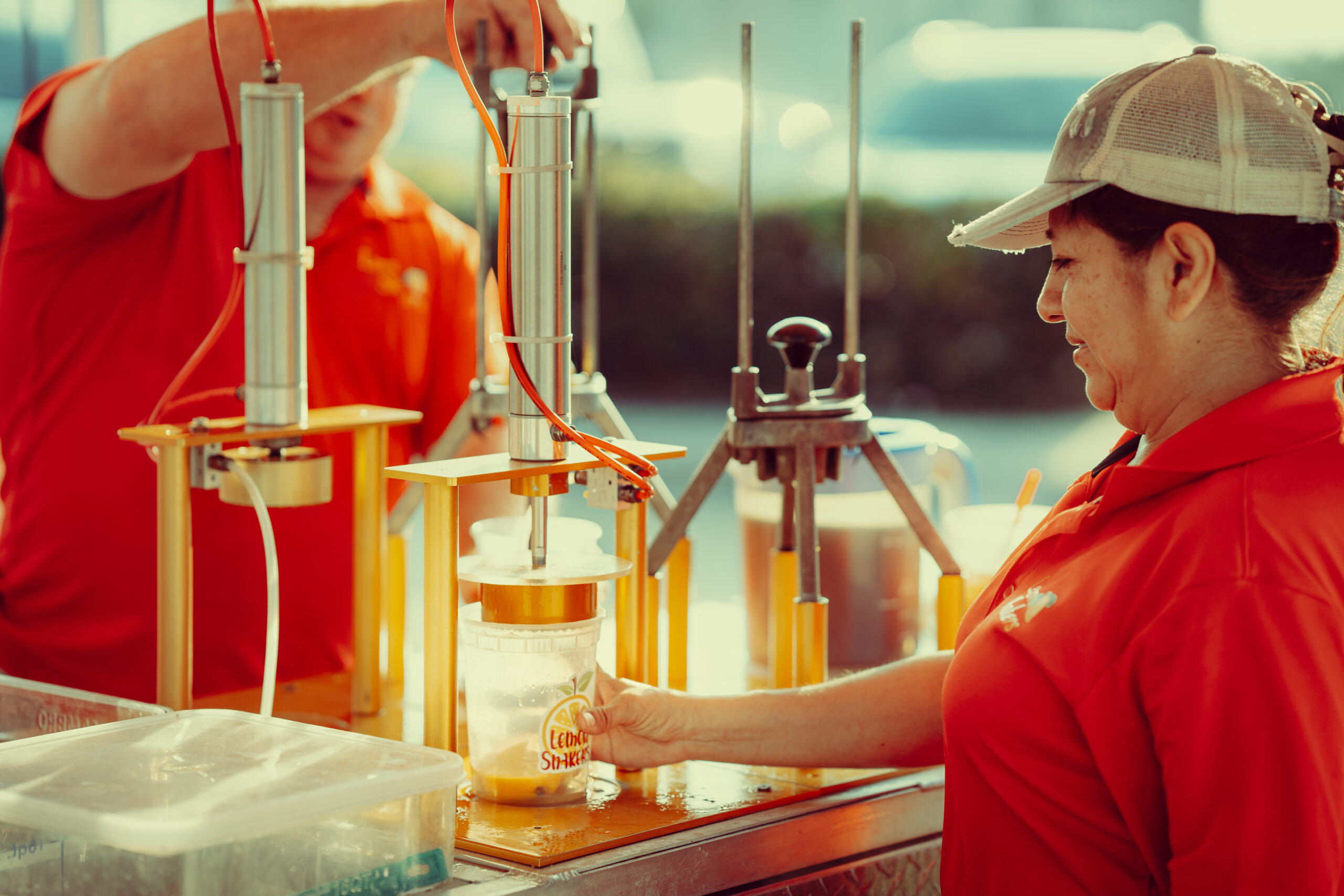 Sylvia and Marvin Kerr, owners of Corpus Christi pop-up lemonade stand Lemon Shakers, shown pressing lemons for the fresh and tasty drink.