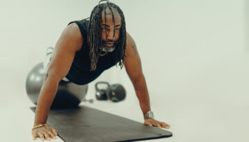 Christian Smalls of ChangeLfe performs a plank while discussing his personal weight-loss journey and the success of his clients.
