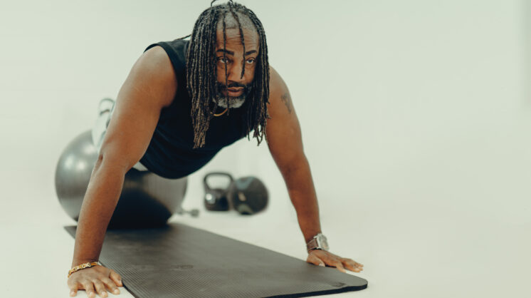 Christian Smalls of ChangeLfe performs a plank while discussing his personal weight-loss journey and the success of his clients.