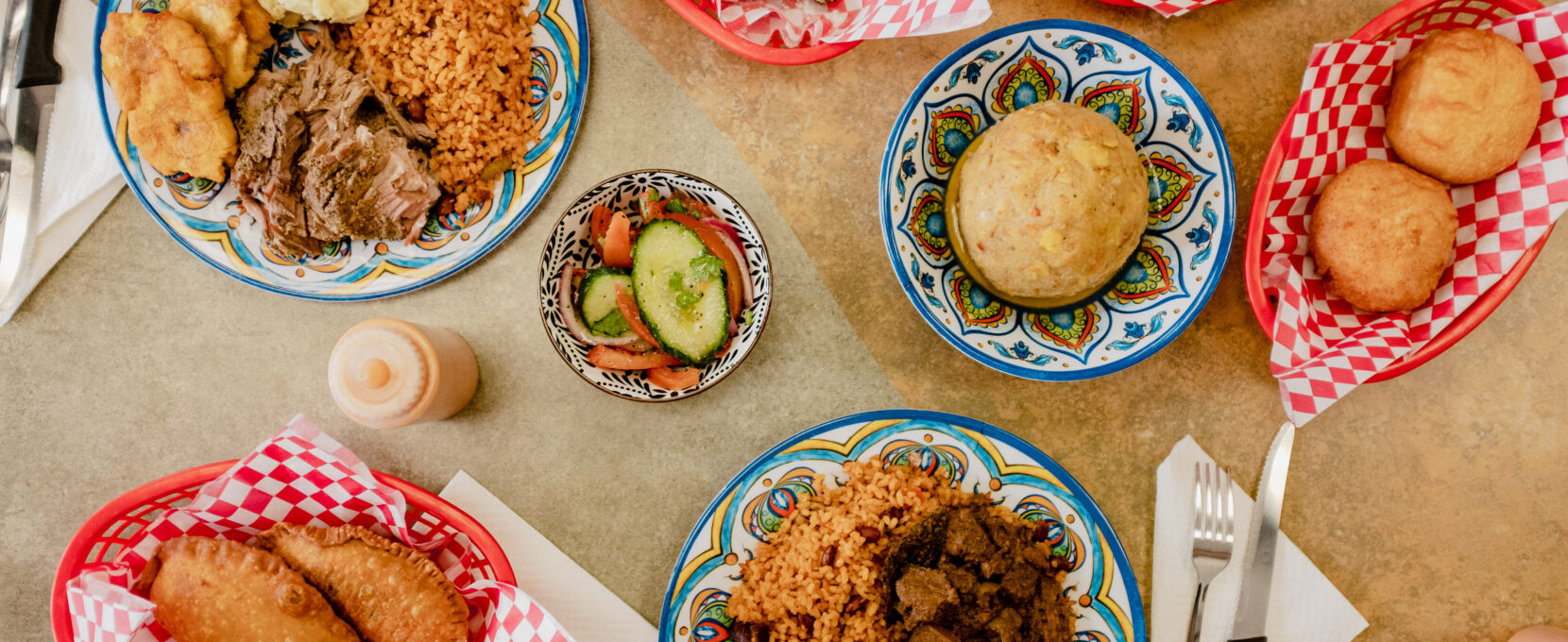 A table at El Taino with a variety of savory dishes, bringing a taste of Puerto Rico to Corpus Christi's South Side.