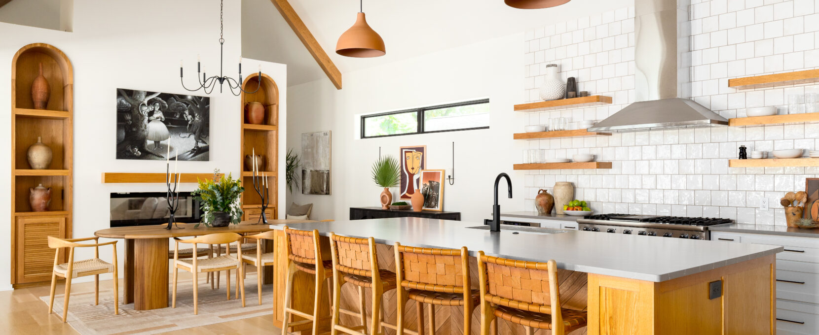 A bright and open kitchen and dining space with natural wood finishes fills the space of this Hyde Park home in Corpus Christi.