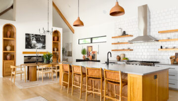 A bright and open kitchen and dining space with natural wood finishes fills the space of this Hyde Park home in Corpus Christi.