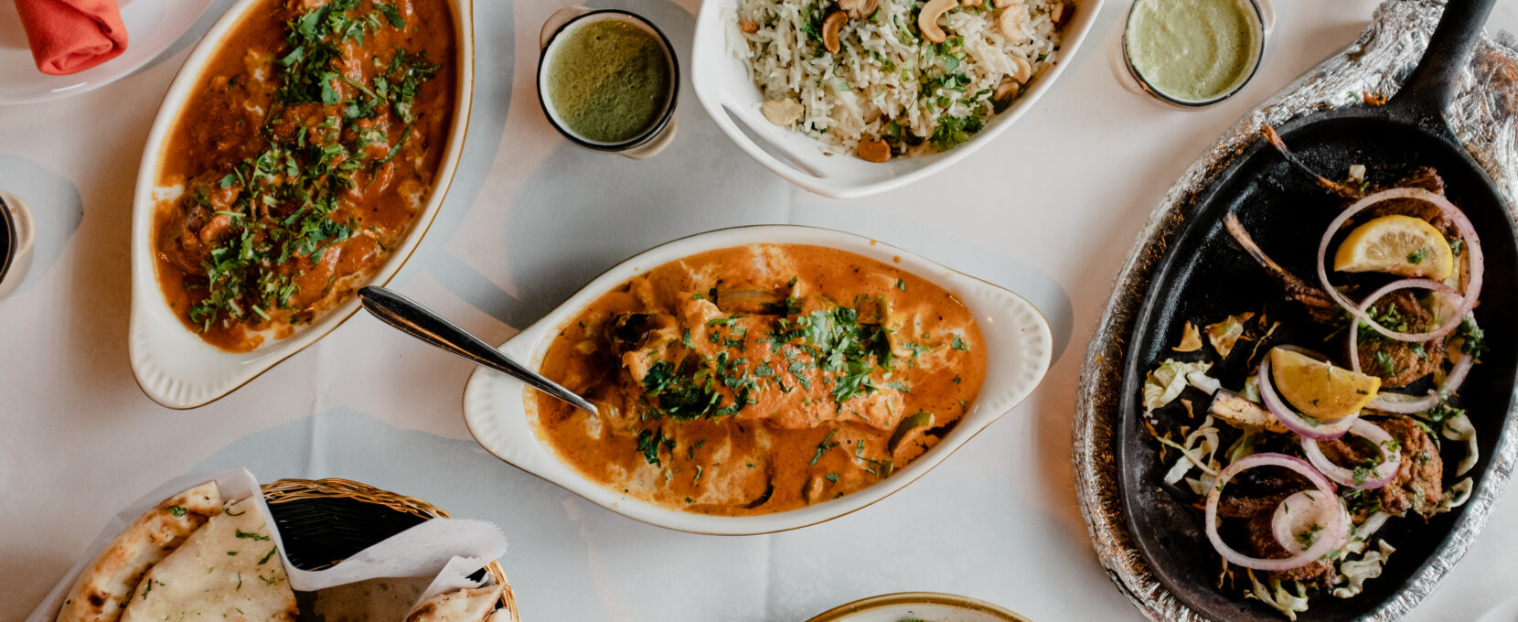 A table full of several Indian dishes at Persis Indian Grill in Corpus Christi.