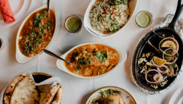 A table full of several Indian dishes at Persis Indian Grill in Corpus Christi.