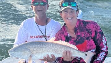 Captain Randy Laurrell catches redfish with Red Tag Guide Service