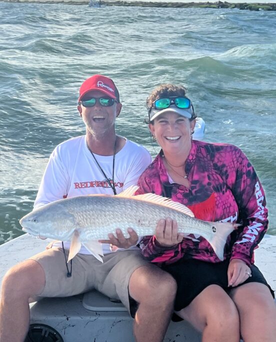 Captain Randy Laurrell catches redfish with Red Tag Guide Service