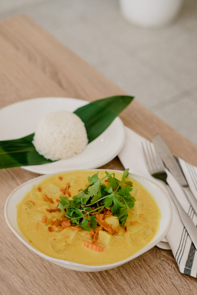 Curry and white rice plated on a table at BKK thai kitchen in Corpus Christi.