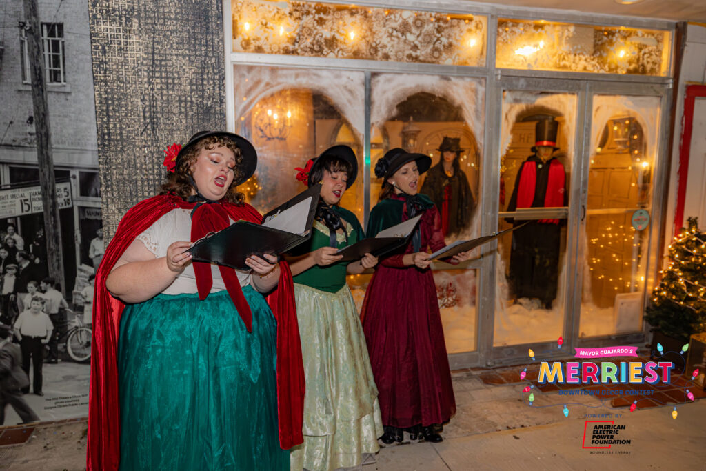Carolers sing outside The Ritz Theatre in Corpus Christi. 