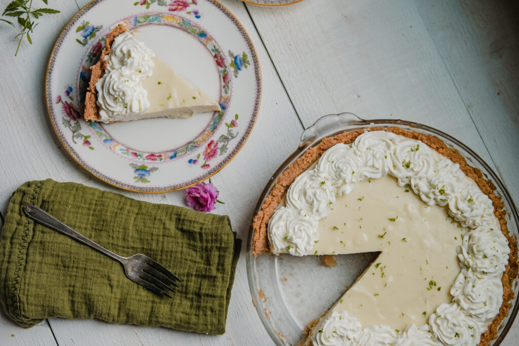 Key lime pie cut and plated for a holiday meal.