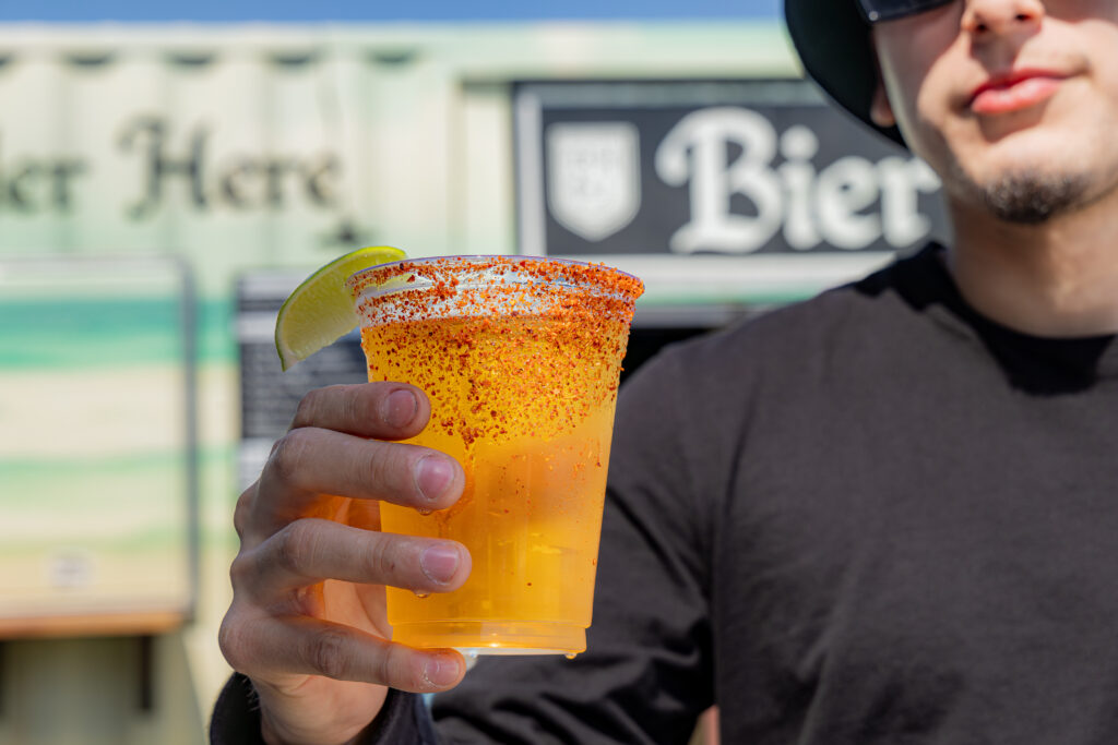 A customer at Bier Haus in Port Aransas, Texas hold a beer.