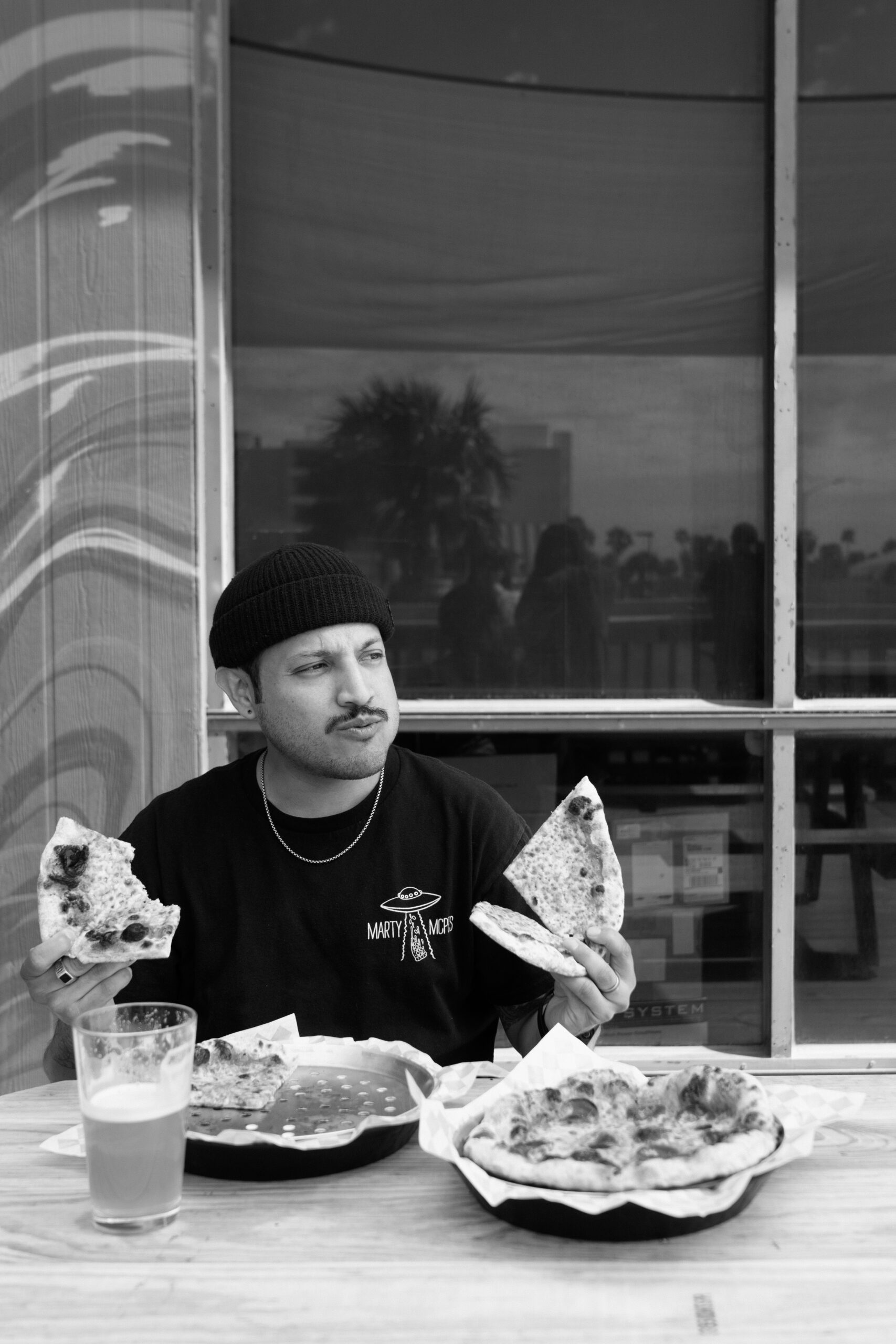 Photo of Martin Flores, owner of Marty McPies, in front of his new restaurant