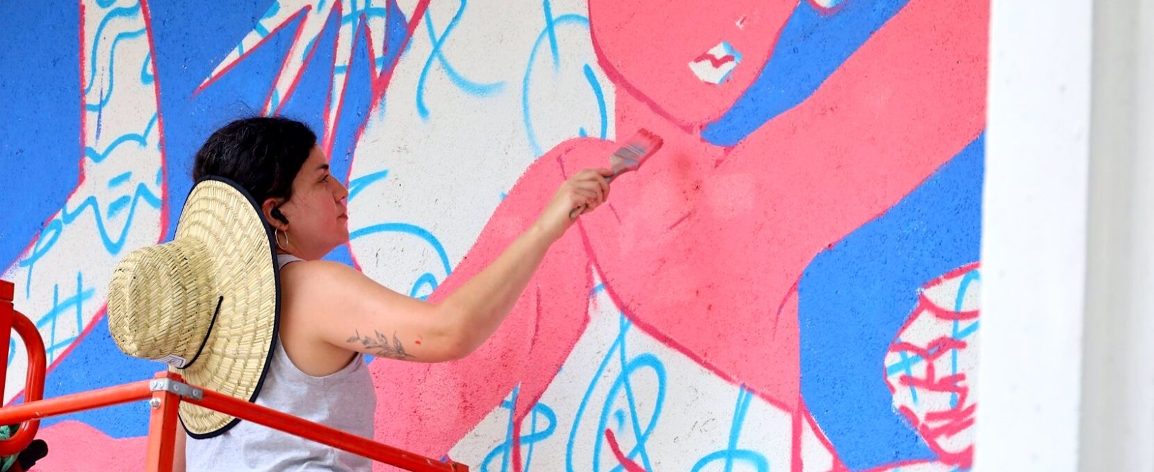 Artist painting one of five new murals in downtown Corpus Christi.
