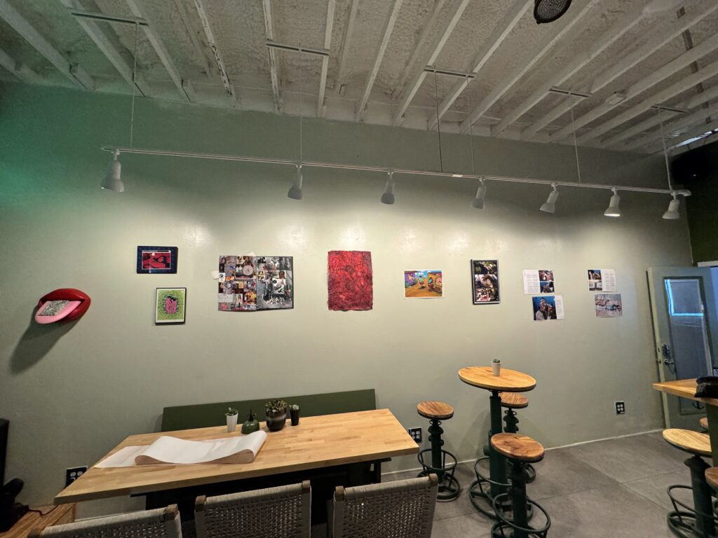 An array of artwork from LGBTQIA+ Exhibition Where Do We Go? inside Produce Bar in downtown Corpus Christi, Texas.