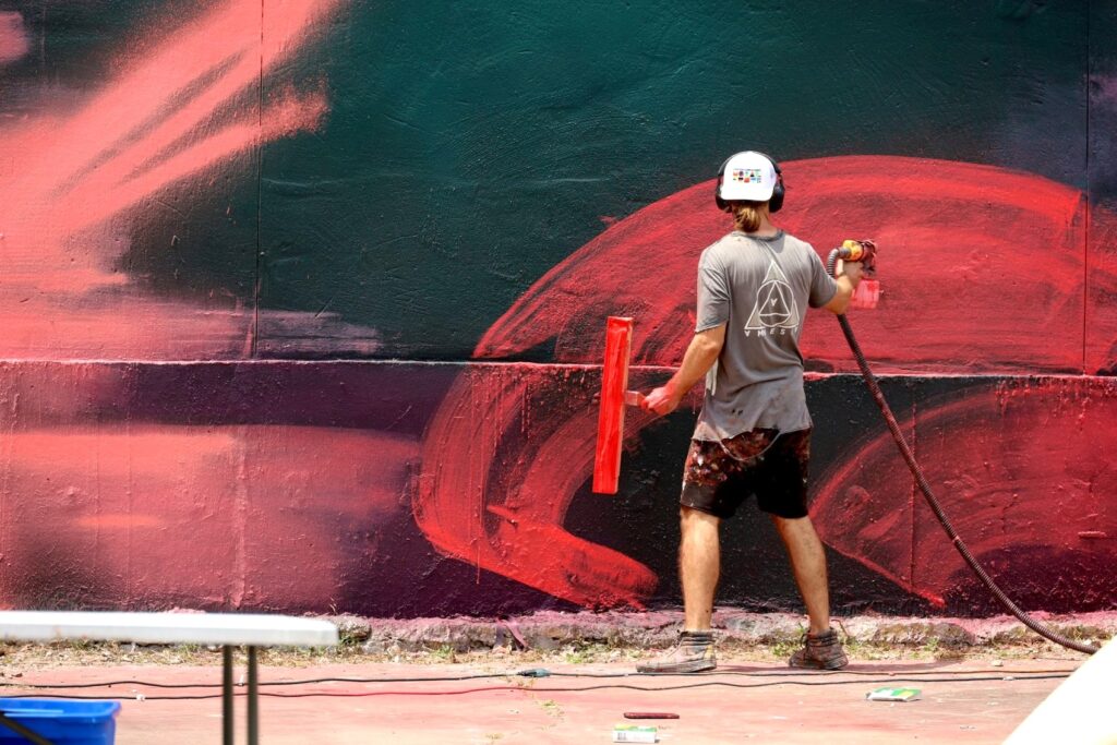 Artist painting one of five new murals in downtown Corpus Christi.