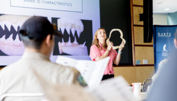 Dr. Kesley Banks presents a shark jaw bone in Corpus Christi, Texas.