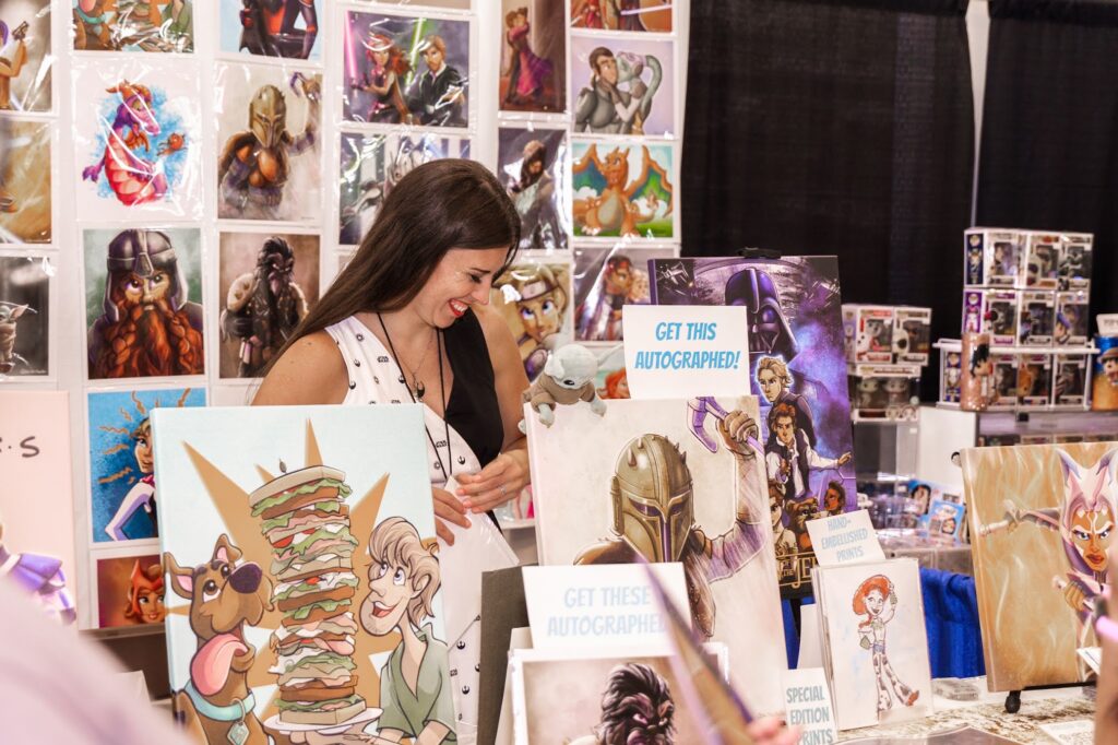 A candid photo of a vendor at Corpus Christi Comic Con at her booth.