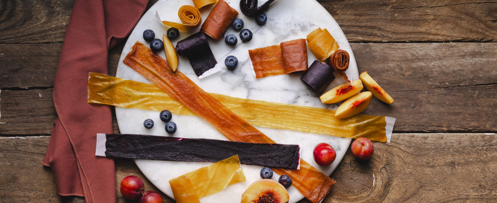 Homemade fruit roll ups on a plate to show a recipe.
