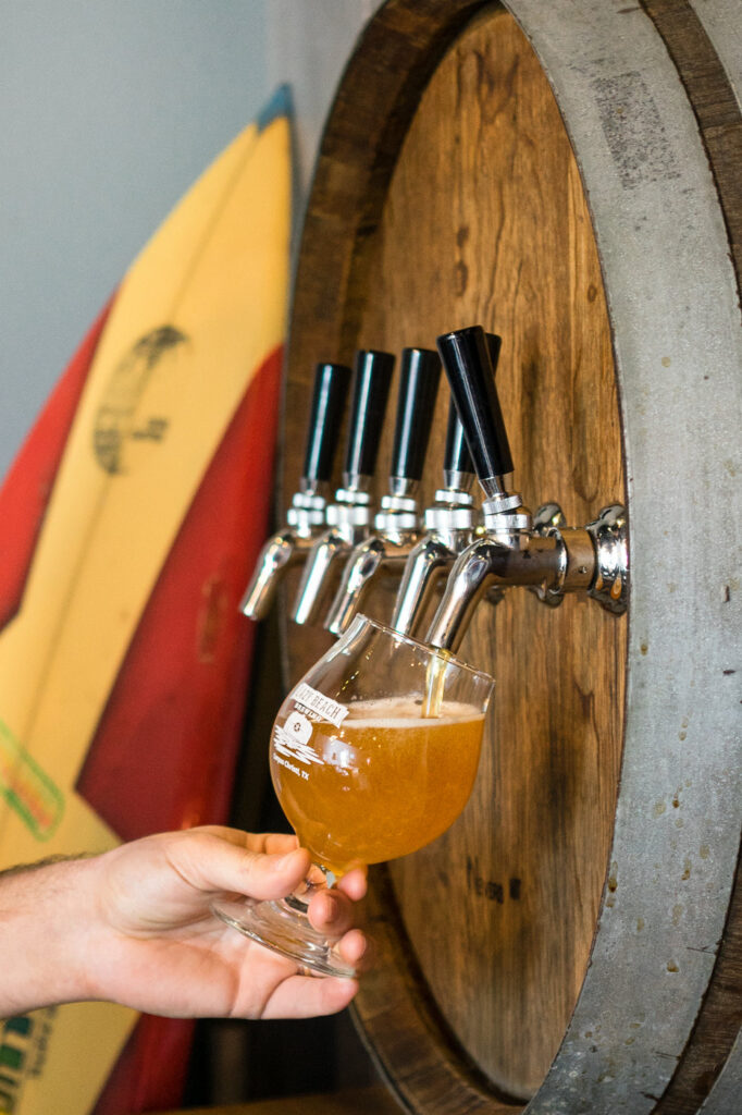 A bartender fills a cup with fresh brew from Lazy Beach Brewing in Corpus Christi, Texas.
