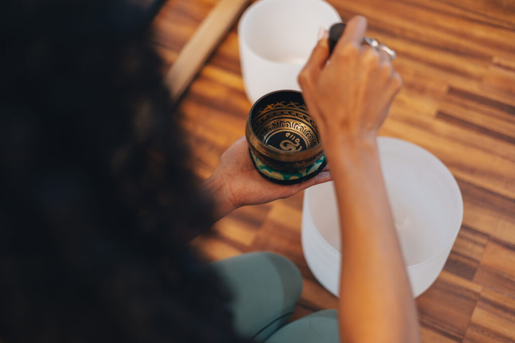 A woman from Sacred Sisters Wellness in Corpus Christi practicing sound meditation. 