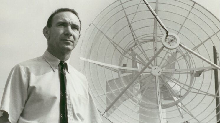 Station Director Hank Schultz poses with the station’s satellite equipment, 1966