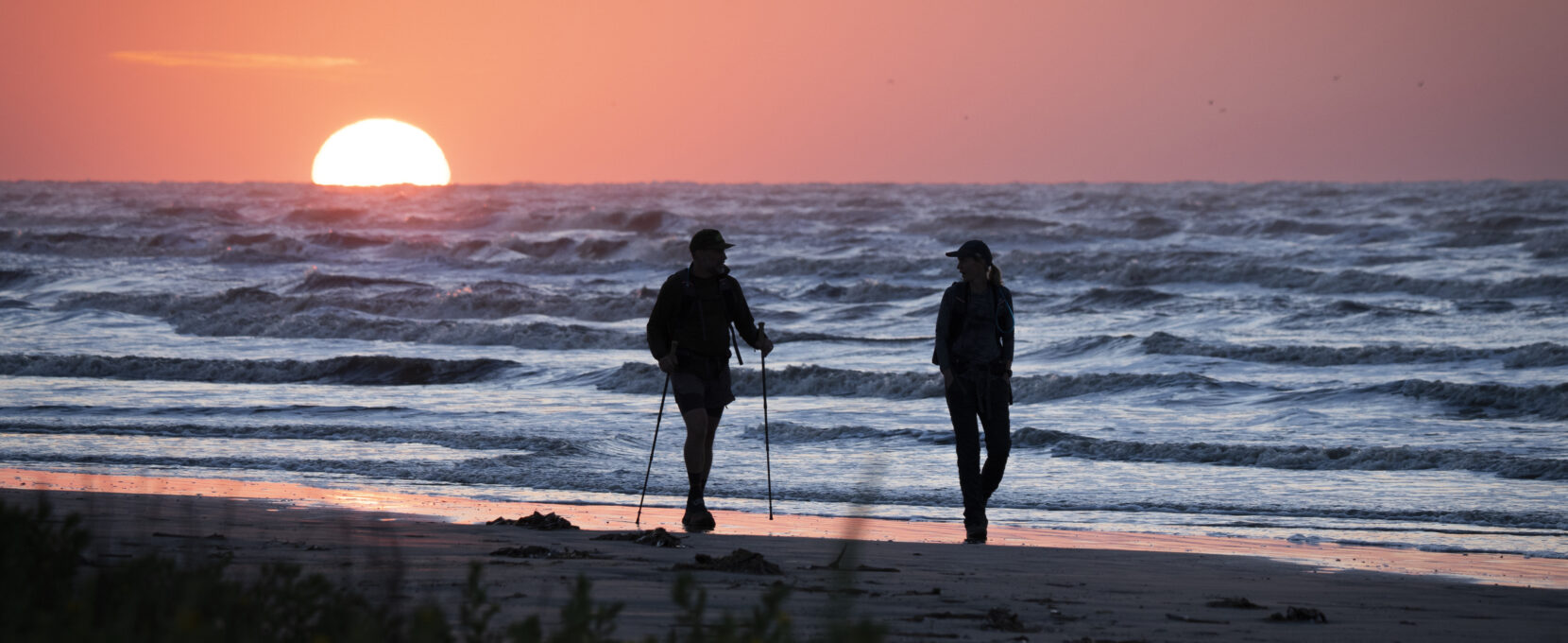 Chrissy and Jay Kleberg walking on the beach at Galveston Island as part of the Chasing the Tide Documentary.