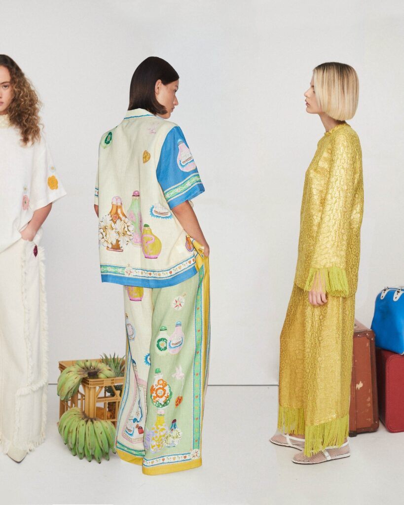 Three women posing in clothing from the Australian brand ALÉMAIS. 