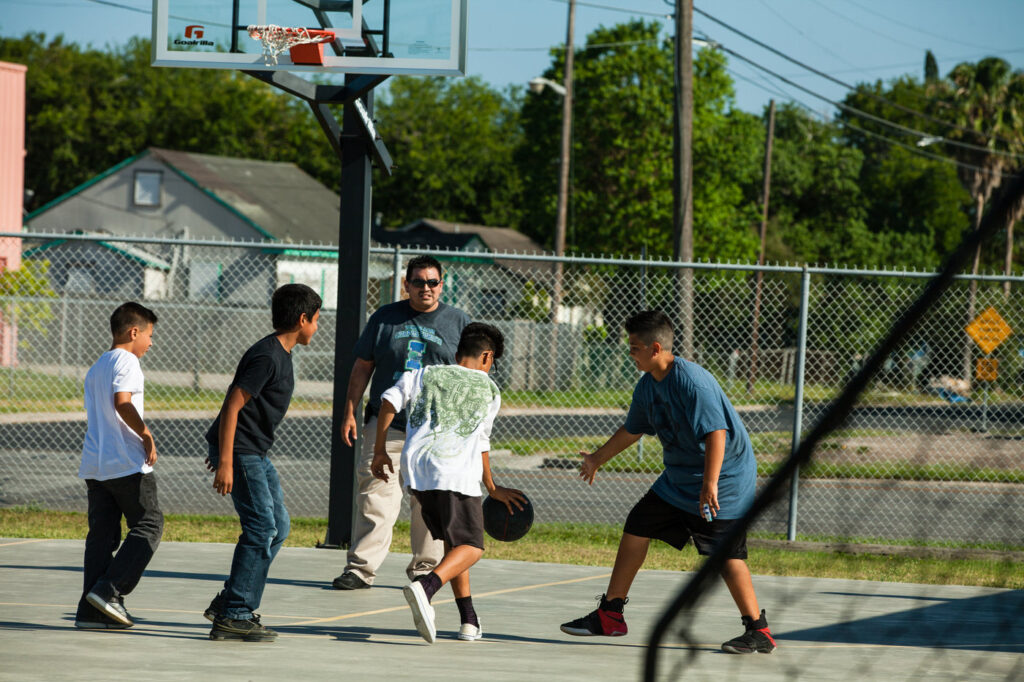 Kids at West Side Helping Hands playing basketball. 