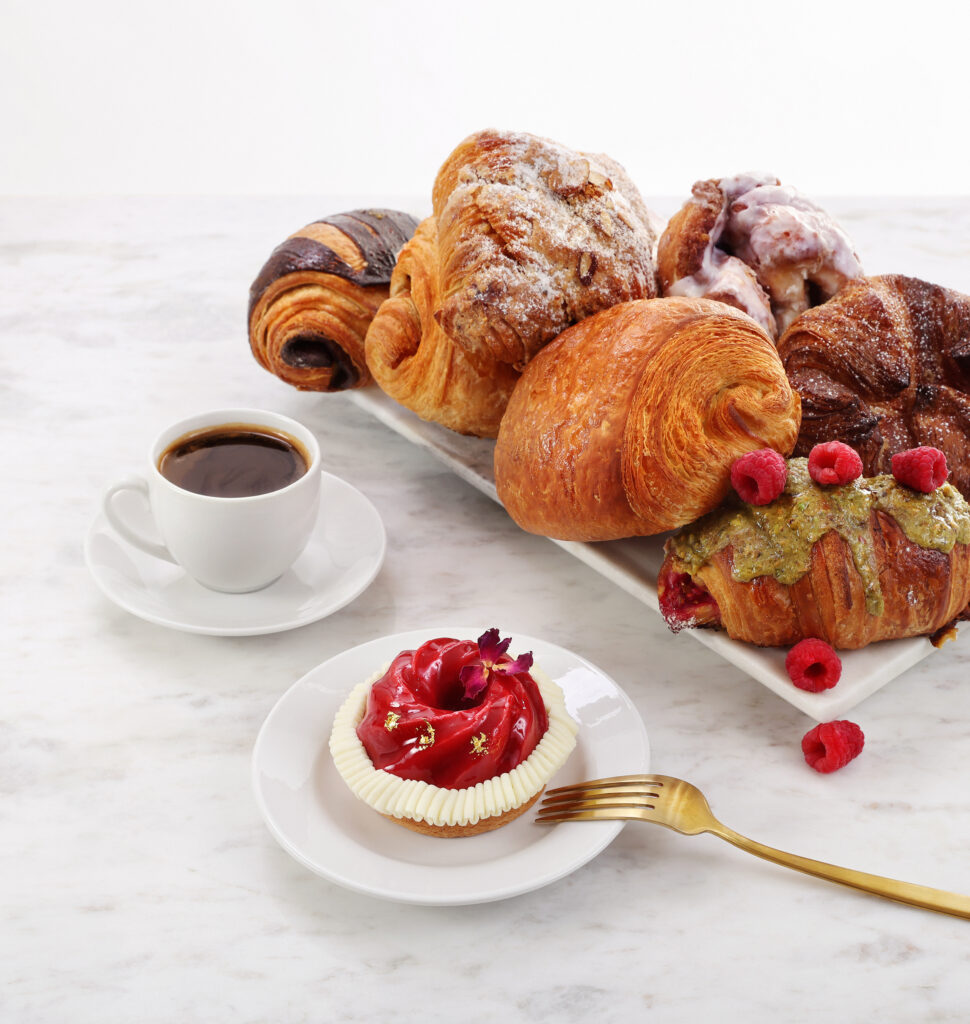 A platter of pastries and an espresso cup.