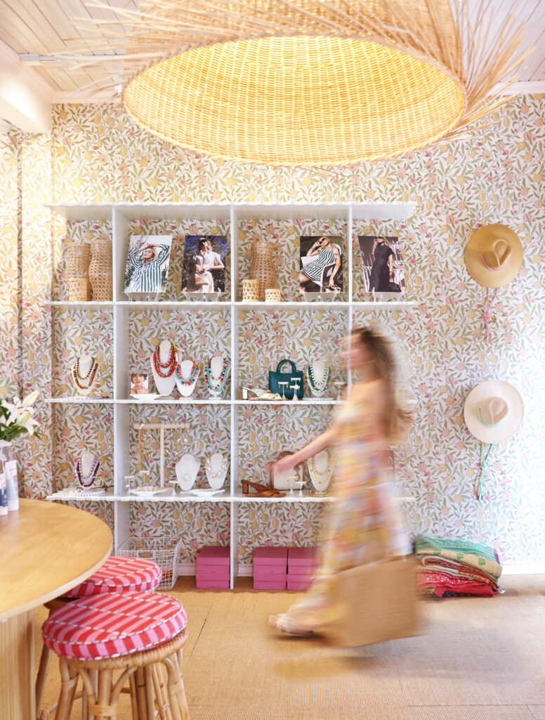 A girl walks past a shelf of inventory at Lady Capitan in Rockport, Texas.