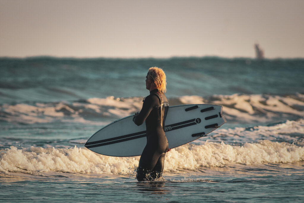 A local surfer stands in the waves in Corpus Christi, Texas. 