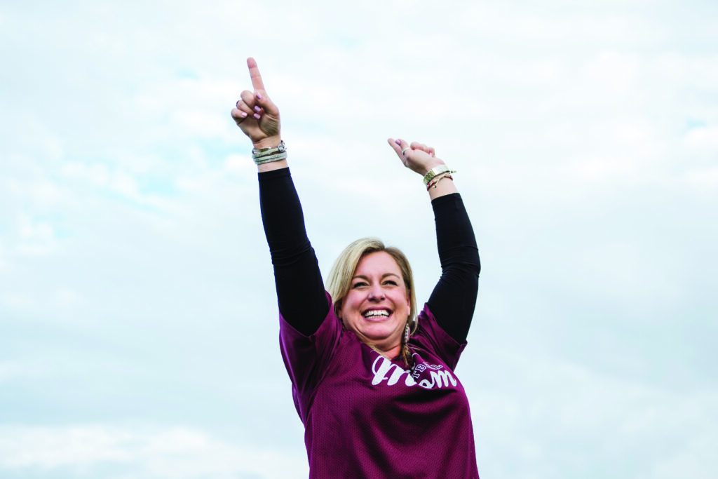 A Callelen football mom cheers on the team.
