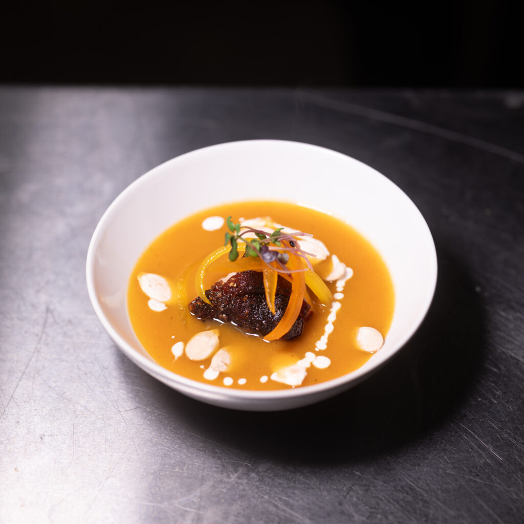 A bowl of soup on a table at Boarri Craft Meats in Corpus Christi. 