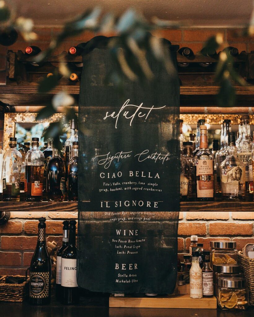 a drink menu written on a fabric creates a banner.