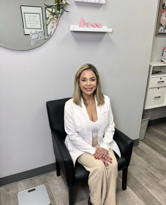 Nurse Practitioner, Eliana Irigoyen with Corpus Christi Plastic Surgery seated in a chair.
