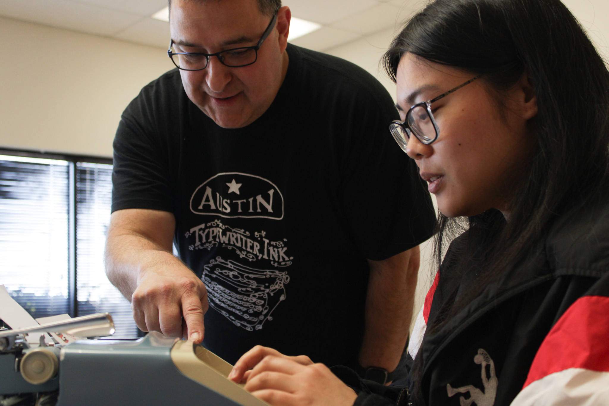 David Torres of Austin Typewriters, ink instructs Tiara Sision. 