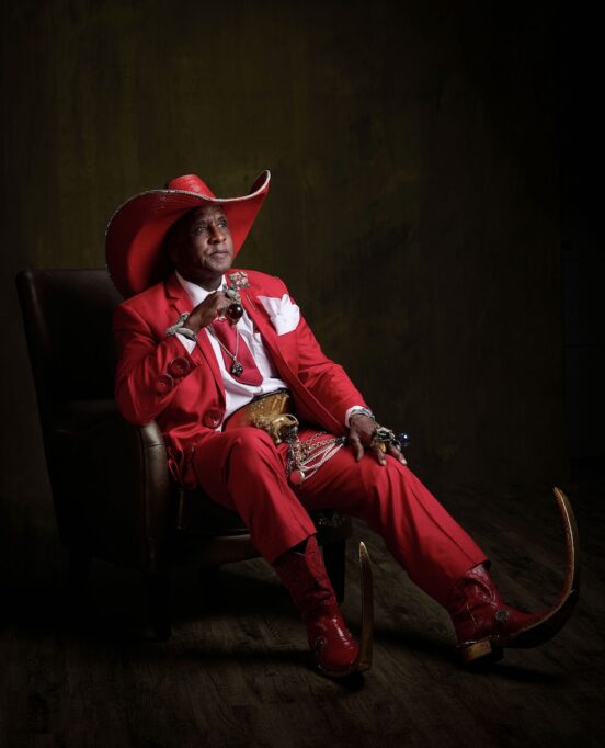 Ronnie Pointy Boots Mathis poses in a chair.