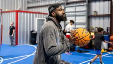 Jacolby Satterwhite shoots a basketball inside his training center, Supreme Athletics Training Center.