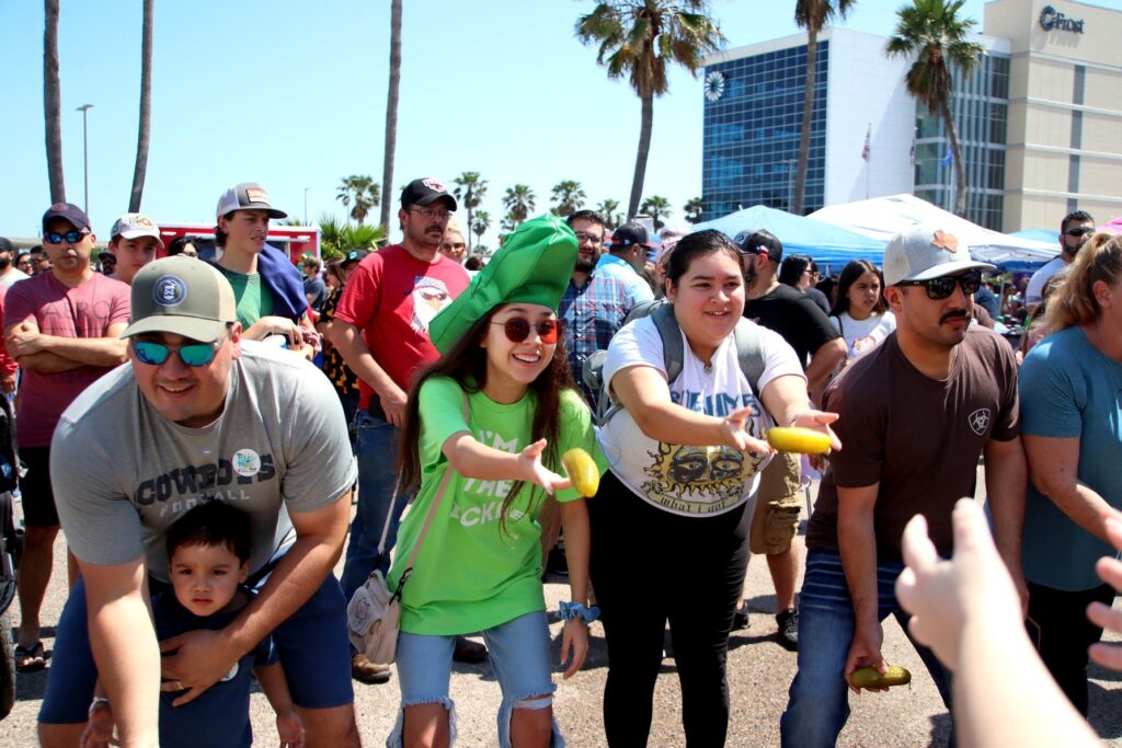 A group of people play "pickle toss" as Nuecess Brewing's Annual Picklefest. 