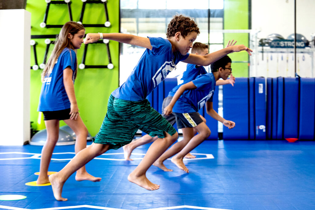 KidStrong Corpus Christi kids sprinting across the mat. 