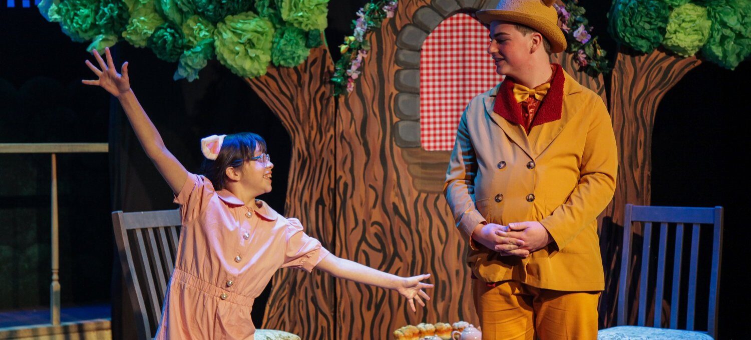 Two kids performing on stage at the Aurora Arts Theatre Summer Camp.