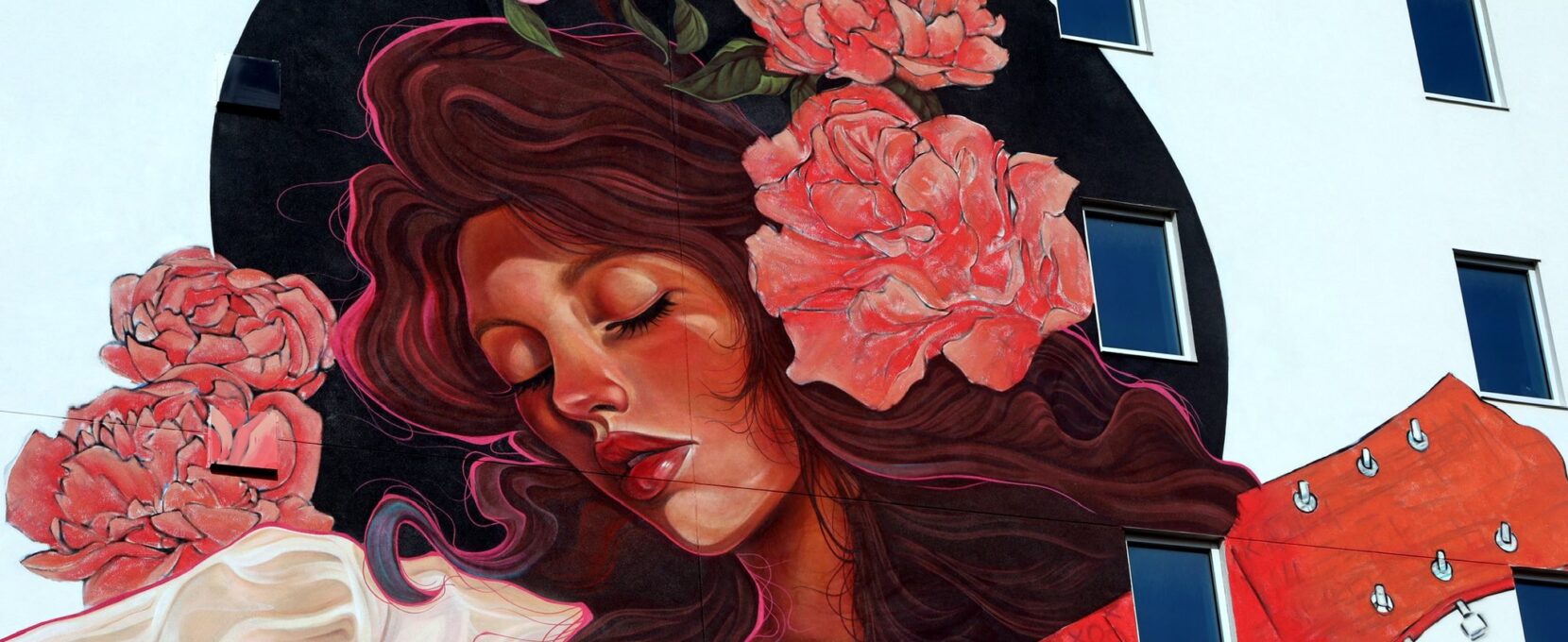 Mandi Caskey aka Miss Birdy, paints a female musician for Mural Fest 2025 in Downtown Corpus Christi.